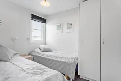 a bedroom with two beds and a cabinet at 417-Vestervig-Havnevej-1-lejl-17 in Vestervig