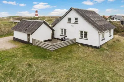 a white house sitting on top of a grass field at 827-Thisted-Orredvej-11 in Thisted