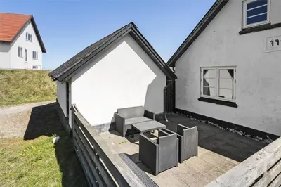 a house with a patio with a chair and a bench at 827-Thisted-Orredvej-11 in Thisted