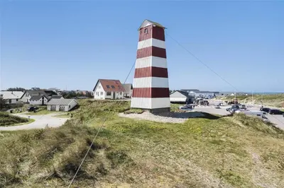 a red and white lighthouse sitting on top of a hill at 827-Thisted-Orredvej-11 in Thisted