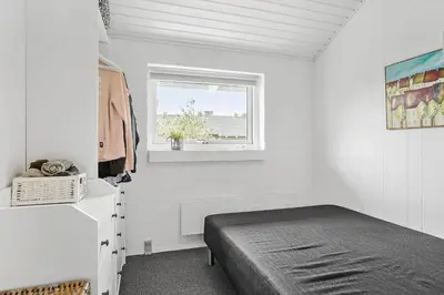 a small bedroom with a bed and a window at 760-Thisted-Pighvarvej-30 in Thisted