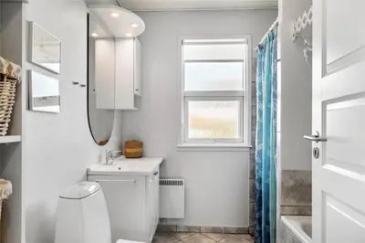 a bathroom with a toilet and a sink and a window at 659-Thisted-Orredvej-7 in Thisted