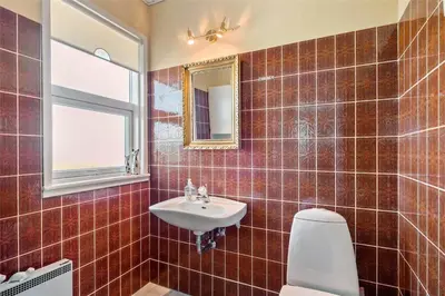 a bathroom with a sink and a toilet and a mirror at 659-Thisted-Orredvej-7 in Thisted
