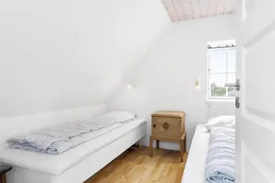 a white room with a bed and a window at 222-Thisted-Nordsovej-57 in Thisted