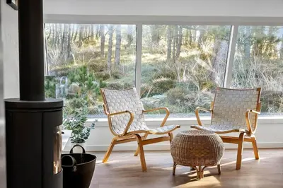two chairs sitting in front of a window at 1315-Thisted-Sandtornvej-15 in Thisted