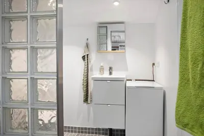 a bathroom with a white refrigerator and a sink at 1315-Thisted-Sandtornvej-15 in Thisted