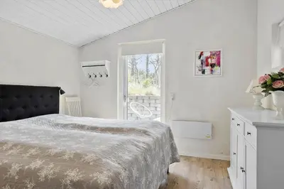 a white bedroom with a bed and a window at 458-Thisted-Sandtornvej-18 in Thisted