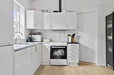a white kitchen with white appliances and white cabinets at 458-Thisted-Sandtornvej-18 in Thisted