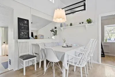 a white dining room with a white table and chairs at 458-Thisted-Sandtornvej-18 in Thisted