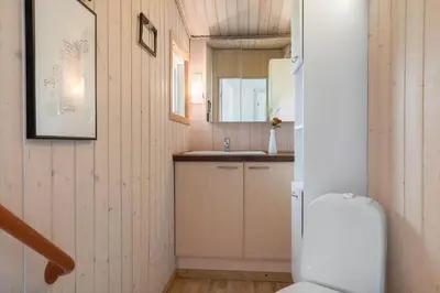 a small bathroom with a toilet and a sink at 619-Thisted-Blabaervej-32 in Thisted