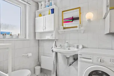 a white bathroom with a sink and a washing machine at 271-Thisted-Nordsovej-88 in Thisted