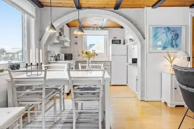 a kitchen and dining room with a white table and chairs at 271-Thisted-Nordsovej-88 in Thisted