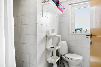 a white bathroom with a toilet and a window at 271-Thisted-Nordsovej-88 in Thisted