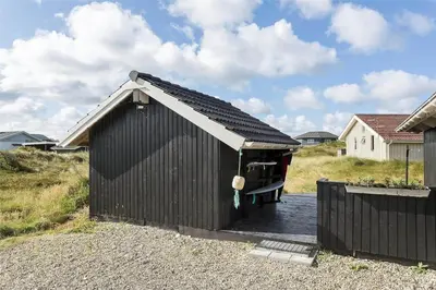 a small black shed with a roof on a driveway at 938-Thisted-Niels-Vognmands-Vej-8 in Torsted