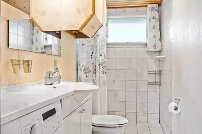 a bathroom with a sink and a toilet and a window at 882-Thisted-Nordsovej-100 in Thisted
