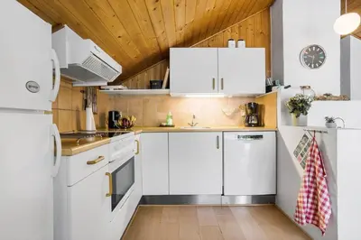 a kitchen with white appliances and a wooden ceiling at 834-Thisted-Revlingvej-9 in Thisted