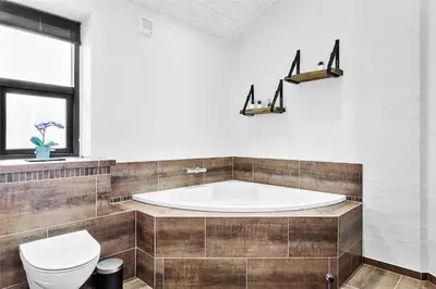a bathroom with a tub and a toilet at 927-Thisted-Spanggardsvej-77 in Torsted