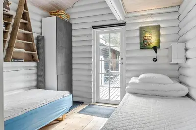a bedroom with a bed and a ladder and a window at 997-Thisted-Lyngstien-15-B in Torsted