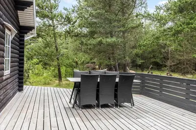 a table and chairs on a wooden deck at 997-Thisted-Lyngstien-15-B in Torsted