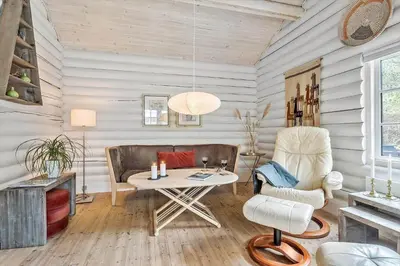 a living room with a table and chairs at 997-Thisted-Lyngstien-15-B in Torsted