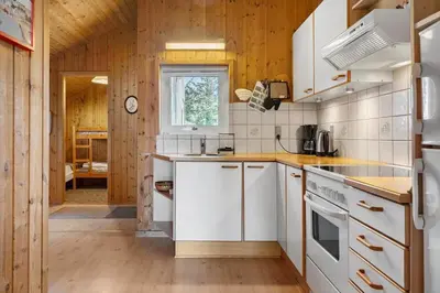 a kitchen with white appliances and wooden walls at 646-Thisted-Bredkaervej-43 in Thisted
