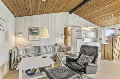 a living room with a couch and a table and chairs at 215-Thisted-Tunvej-29 in Thisted