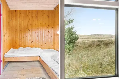 a bed in a wooden room with a window at 861-Thisted-Havbovej-41 in Thisted