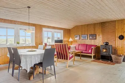 a living room with a table and chairs and a fireplace at 861-Thisted-Havbovej-41 in Thisted