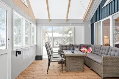 a living room with a couch and a table and chairs at 599-Thisted-Fiskervej-165 in Thisted