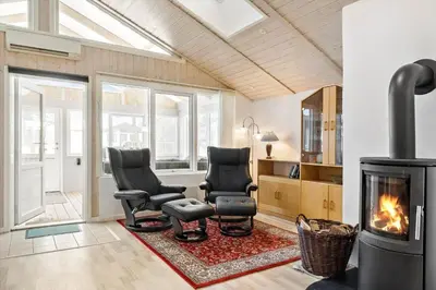 a living room with two chairs and a fireplace at 599-Thisted-Fiskervej-165 in Thisted