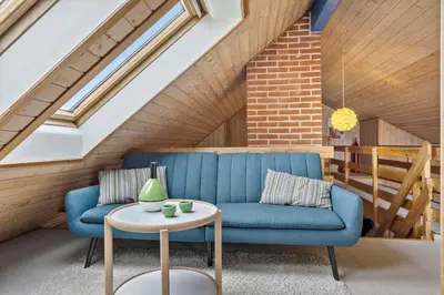 a living room with a blue couch and a table at 376-Thisted-Fiskervej-55 in Thisted