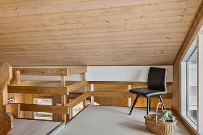 a chair in a room with wooden ceilings at 376-Thisted-Fiskervej-55 in Thisted