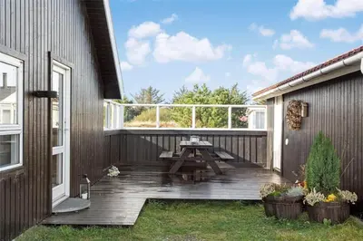 a wooden deck with a picnic table on a house at 376-Thisted-Fiskervej-55 in Thisted
