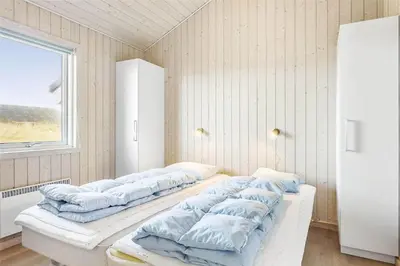 a row of pillows are lined up in a room at 951-Thisted-Bavnbak-39 in Torsted