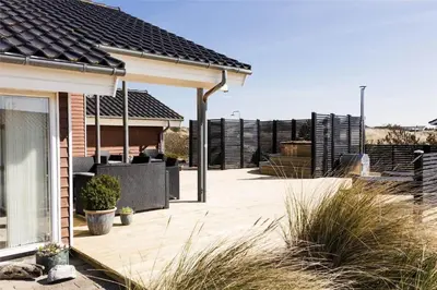 a house with a patio with a fence at 951-Thisted-Bavnbak-39 in Torsted