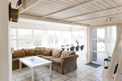 a living room with a couch and a table at 951-Thisted-Bavnbak-39 in Torsted