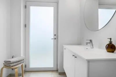 a white bathroom with a mirror and a sink at 1305-Snedsted-Klitfogedvej-5 in Snedsted