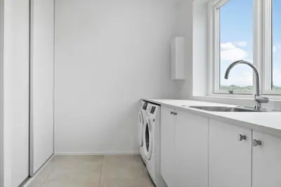 a white kitchen with a sink and a washing machine at 1305-Snedsted-Klitfogedvej-5 in Snedsted