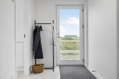 an open door to a room with a refrigerator at 1305-Snedsted-Klitfogedvej-5 in Snedsted