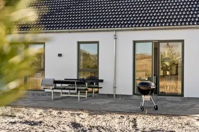 a grill sitting on a patio next to a house at 1305-Snedsted-Klitfogedvej-5 in Snedsted