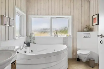 a white bathroom with a tub and a toilet at 866-Thisted-Klemsvej-35 in Thisted