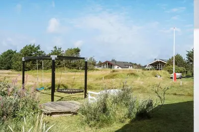 a swing set in the middle of a field at 866-Thisted-Klemsvej-35 in Thisted