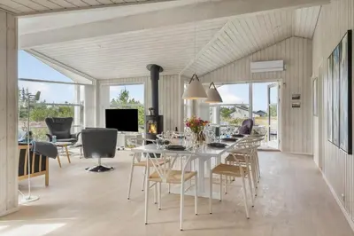 a dining room with a white table and chairs at 866-Thisted-Klemsvej-35 in Thisted