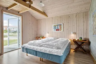 a bedroom with a bed and a large window at 928-Thisted-Kobbelsti-15 in Torsted