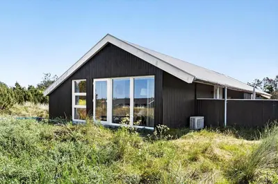 a black house sitting on top of a hill at 572-Thisted-Kristinesvej-7 in Thisted