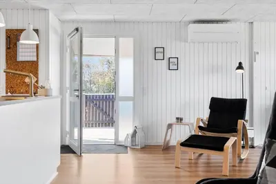 a living room with a chair and a sliding glass door at 572-Thisted-Kristinesvej-7 in Thisted