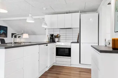 a white kitchen with white cabinets and a refrigerator at 572-Thisted-Kristinesvej-7 in Thisted