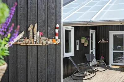 a patio with a chair and a lighthouse shelf on a house at 572-Thisted-Kristinesvej-7 in Thisted