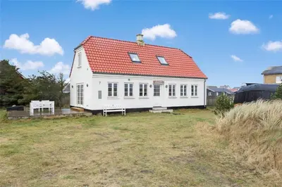 a white house with a red roof on a field at 125-Thisted-Fiskervej-7 in Thisted