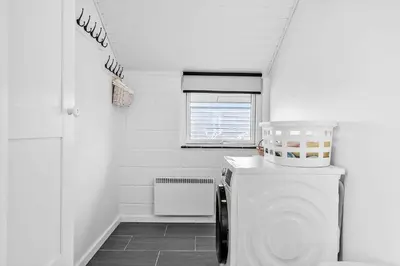 a white bathroom with a toilet and a window at 447-Thisted-Kuttervej-13 in Thisted